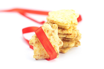 Cookies in the form of a house with red ribbon isolated on white
