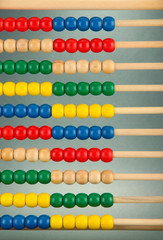 Bright wooden toy abacus, on grey background