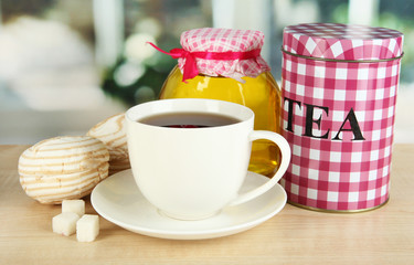 Jar and cup of tea isolated on white