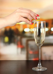 Pour something into glass with drink