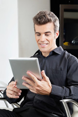 Fototapeta na wymiar Mężczyzna Client przy użyciu cyfrowych Tablet W Salonie