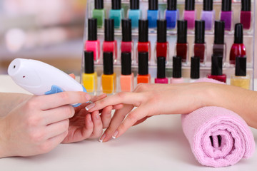 Manicure process in beauty salon, close up