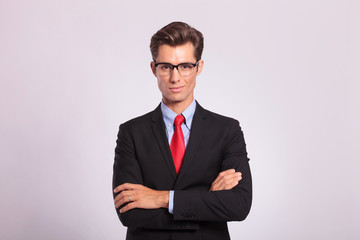 business man standing with hands folded