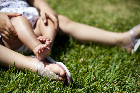 feet of two children on the grass. Tender  picture