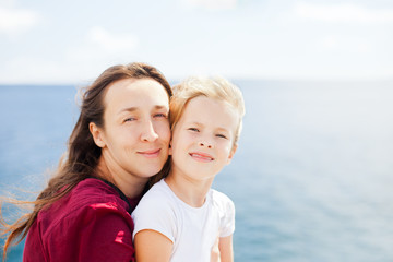Fototapeta na wymiar mother and daughter on sea background