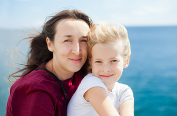 Fototapeta na wymiar mother and daughter on sea background