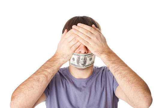 Young man covering his eyes with his hands and his mouth sealed