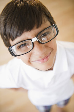 Boy wearing eyeglasses repaired with tape