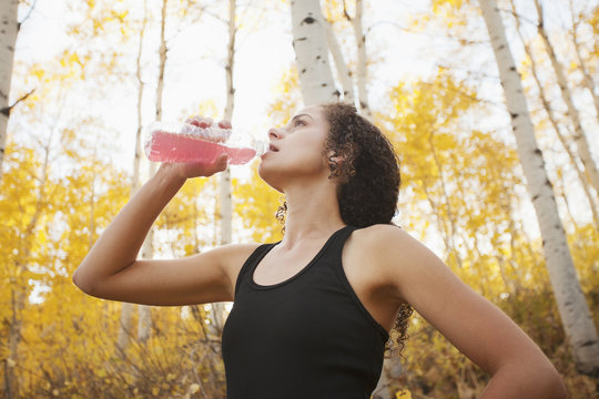 Caucasian woman drinking juice after exercise