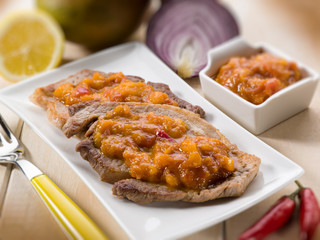 grilled steak with mango sauce, selective focus