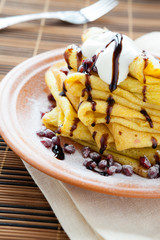 Pancakes with sauce and powdered sugar