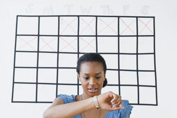 Black woman checking her wristwatch