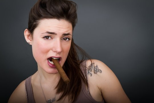 woman smokes cigar
