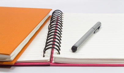 Close-up of pink, orange open note book and pen