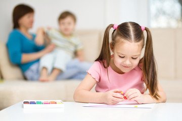 Little girl is playing with plasticine