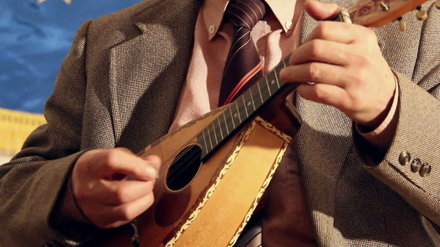 Artist playing mandolin, close up