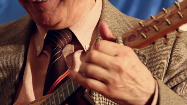 Artist playing mandolin, close up