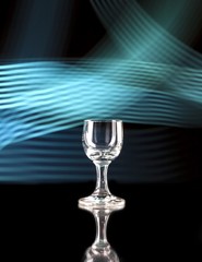 Glass of alcohol on disco background, party