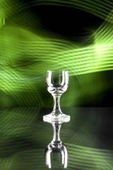 Glass of alcohol on disco background, party