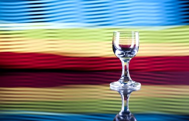 Glass of alcohol on disco background, party