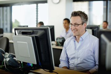 Business people working on computers in office
