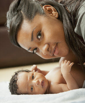 Mixed race mother bonding with newborn baby
