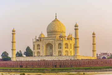 taj mahal from yamuna river in sunset