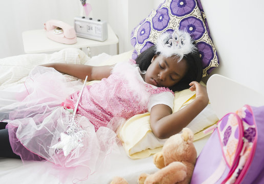Black girl sleeping in fairy costume