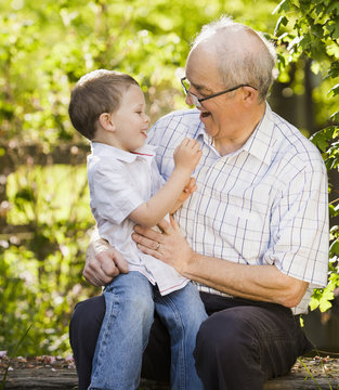 Caucasian grandfather talking with grandson