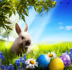art Little Easter bunny and Easter eggs on green grass