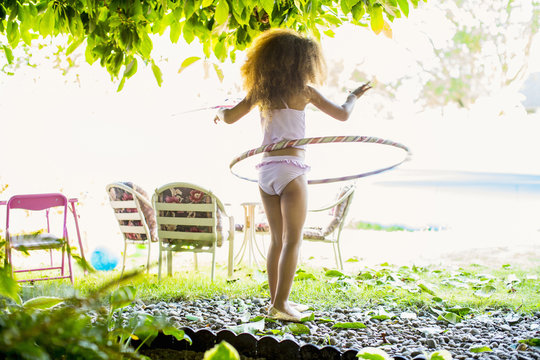 Mixed Race Girl Twirling Plastic Hoop