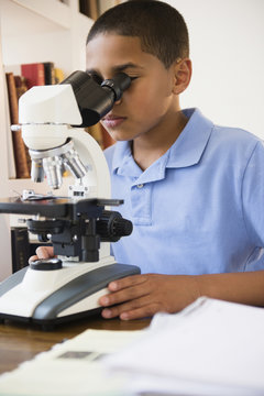 Boy using microscope