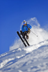 Snow Skier Jumping Against Blue Sky - 50192457