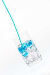 Blue stream falling into a drink