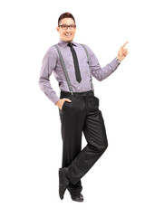 Full length portrait of a stylish smiling male pointing