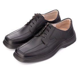 Black glossy man’s shoes with shoelaces