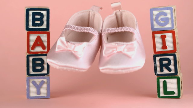 Baby shoes falling between baby blocks
