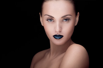 close up portrait of model with stylish makeup, over black