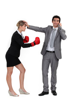 man on the phone and woman with boxing gloves