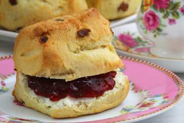 English scone with strawberry jam and clotted cream, close up