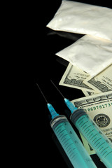 Drugs, money and  syringes, isolated on black