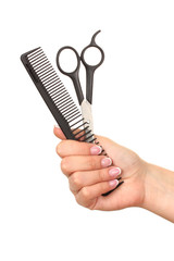 Color comb and scissors in female hand, isolated on white
