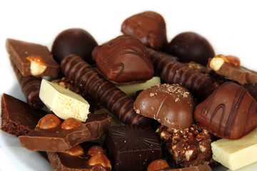 Chocolate and sweets on white plate, close up