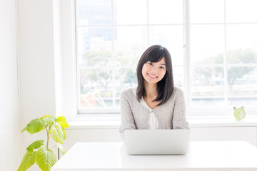 attractive asian woman using laptop