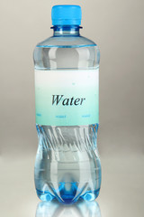 Water bottle with label on grey background