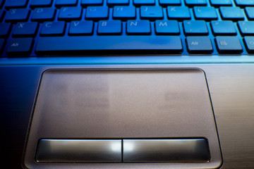 close up of laptop keyboard as a background toned to blue