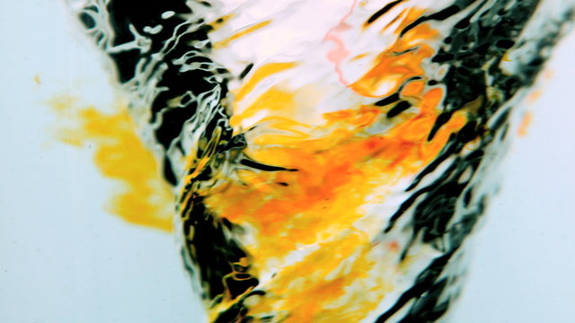 Water whirlpool close up with orange ink