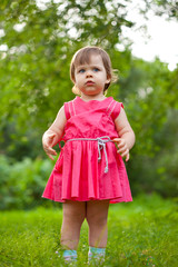 cute little girl stading on meadow