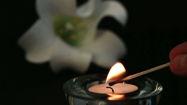 Hand Lighting Candle To Remember Loss