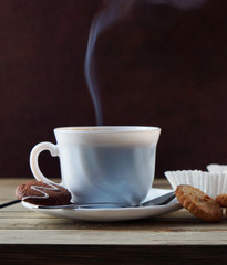 Steaming Cup Of Hot Coffee And Cookies